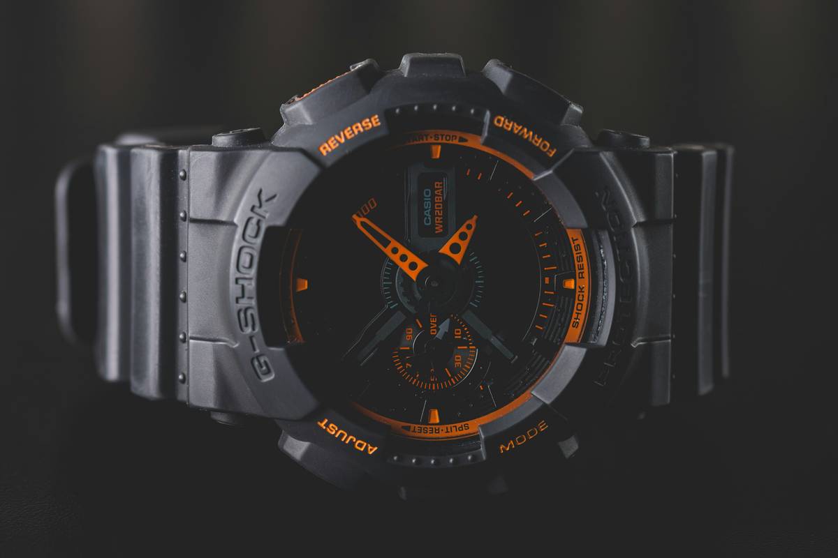 Close-up of a fashion watch with Scratch-Resistant Materials label showing unblemished crystal surface